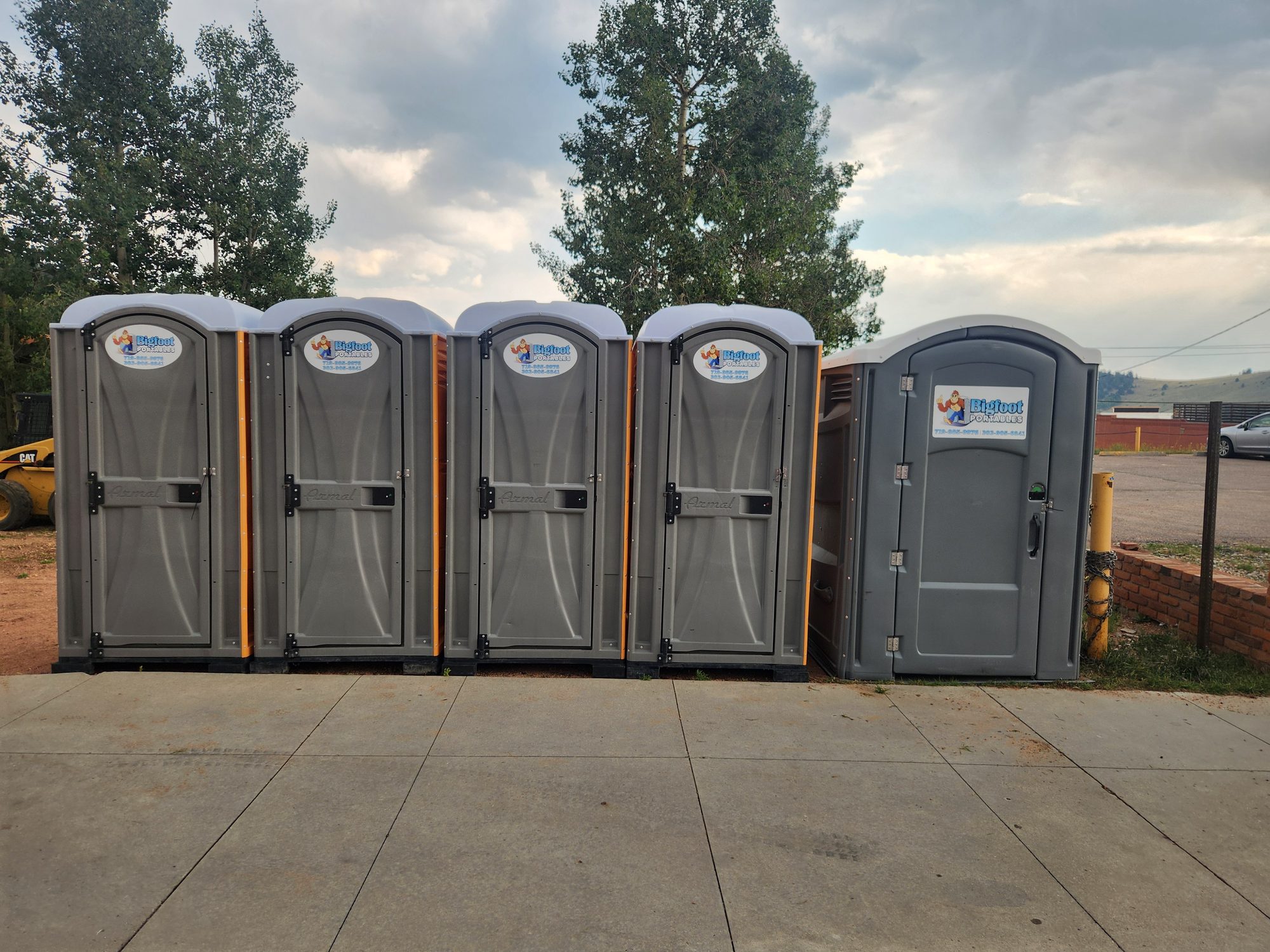 Row of Bigfoot Portables porta potties and an ADA unit at a construction site